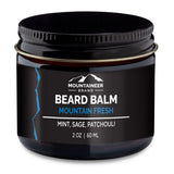 Black jar of Mountaineer Brand Products Natural Beard Balm with "mountain fresh" label, containing natural essential oils of mint, sage, and patchouli, 2 oz 60 ml.