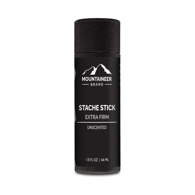 A black bottle of Extra Firm Hold Stache Stick by Mountaineer Brand Products, all natural and free of chemicals, on a white background.